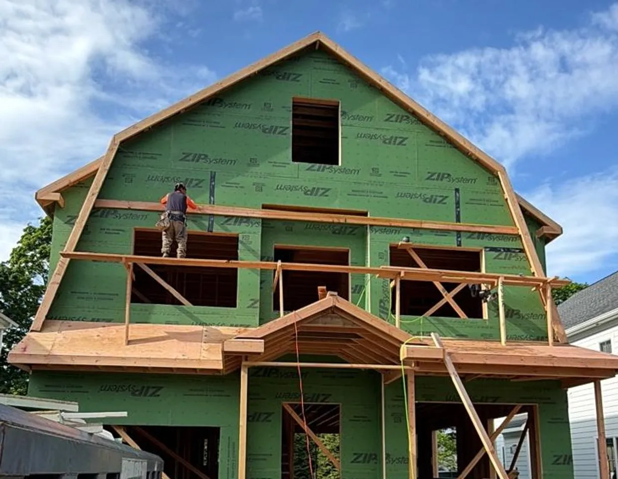 New-construction home framed and wrapped in green ZIP System sheathing by North Valley Exteriors
