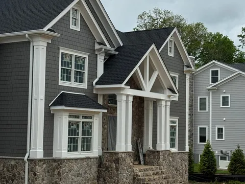 Finished dark-gray shake home with a wraparound porch