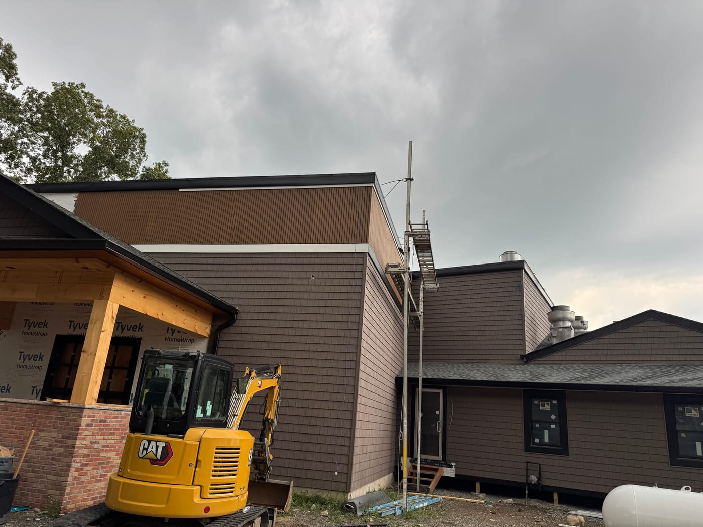 Establishing view of the brown home with the cedar timber porch