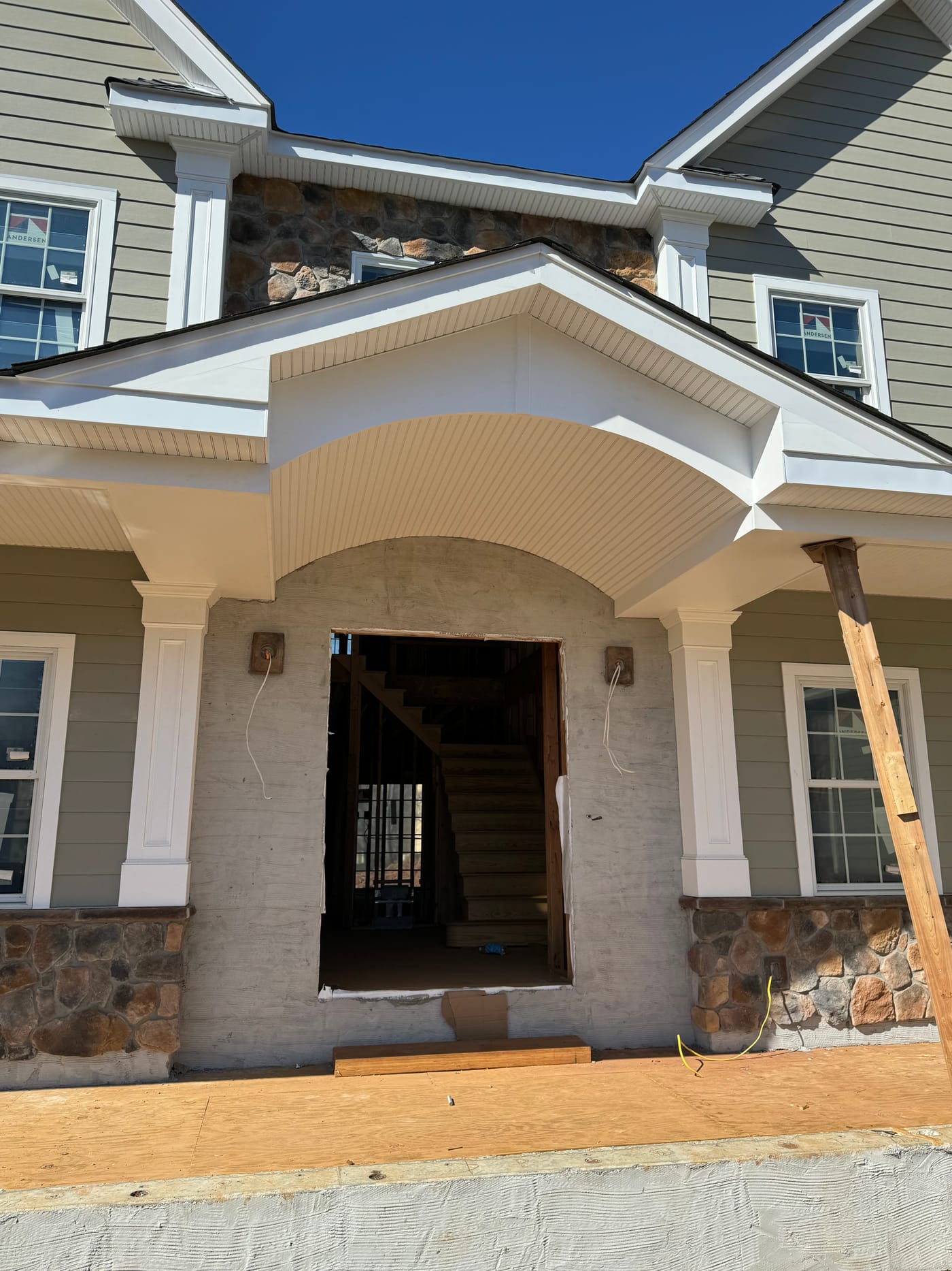 Curved beadboard portico ceiling with columns on stone piers