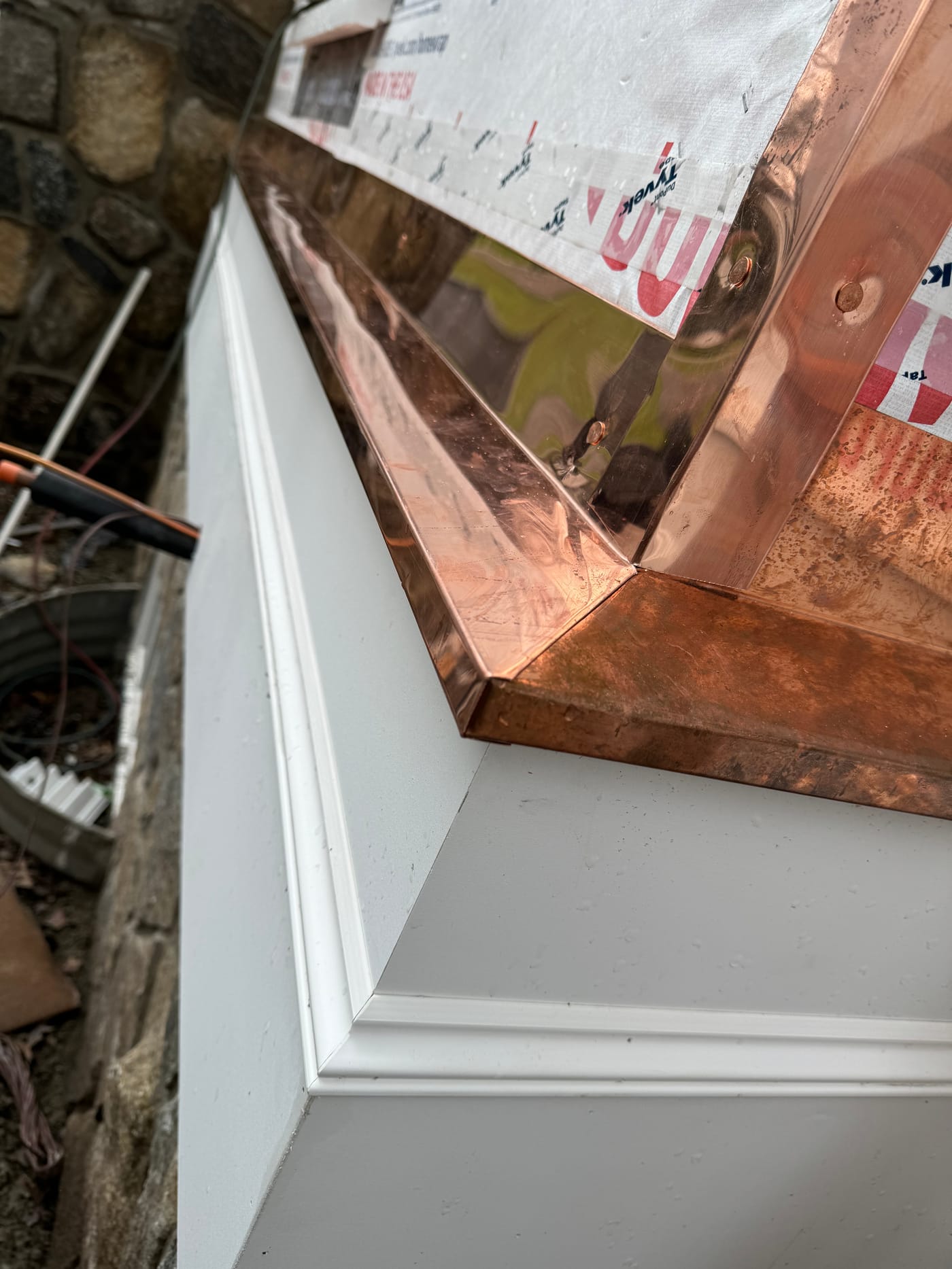 Soldered copper cap detail on white AZEK trim