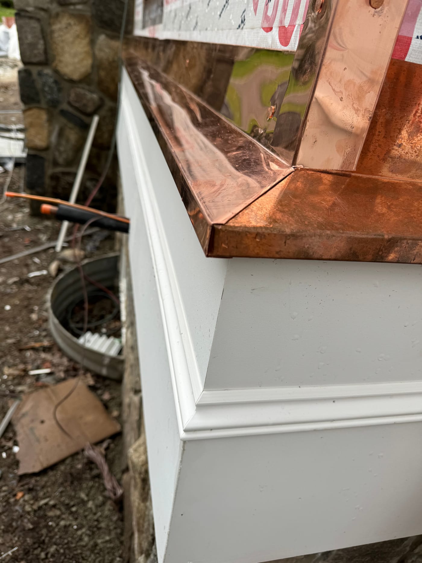 Copper cap and trim box over a fieldstone pier