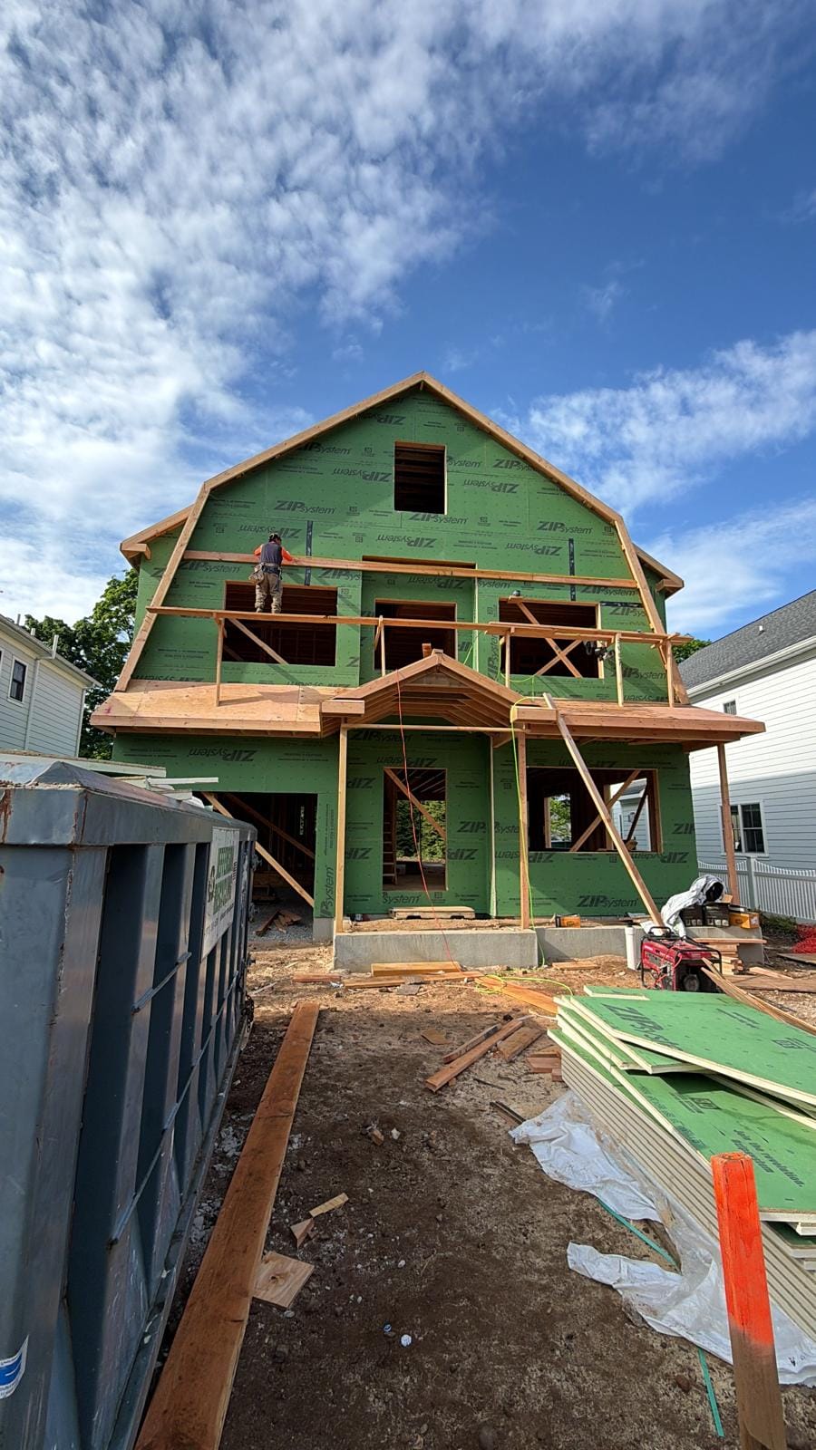 Front elevation fully sheathed in green ZIP System panels with a framed porch
