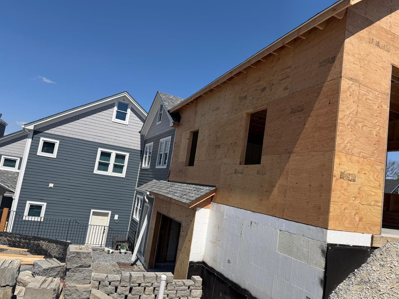 Plywood-sheathed two-story addition with copper entry-hood flashing