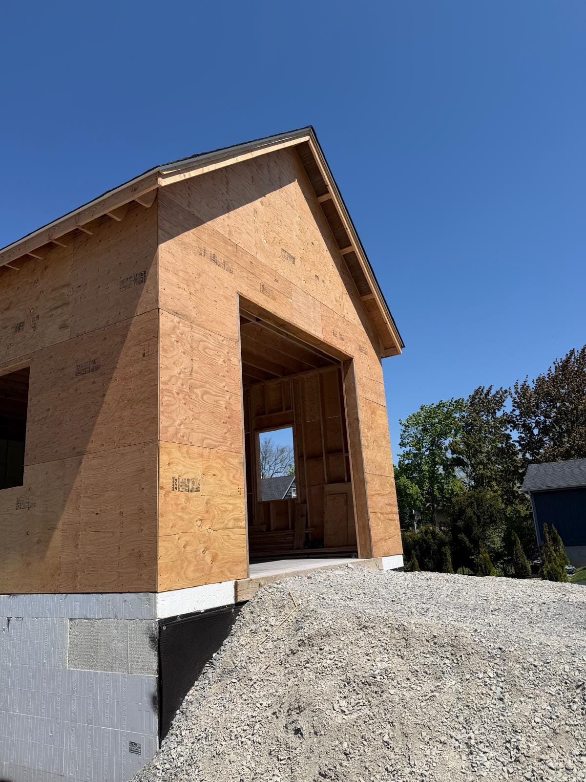 Sheathed gable end with a framed entry opening on the lakefront