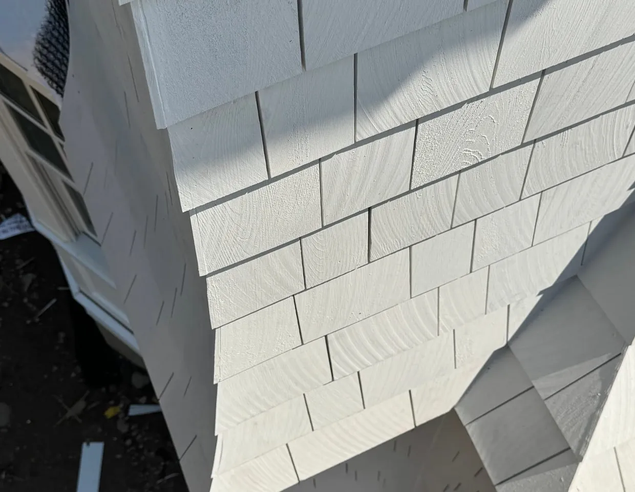 Freshly installed light-gray HardieShingle staggered shake siding by North Valley Exteriors